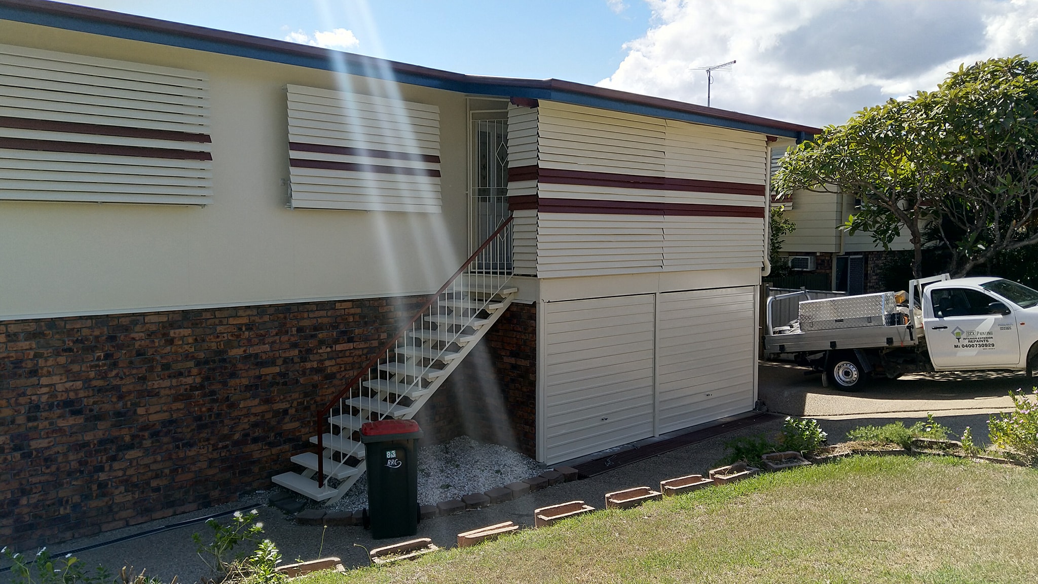 Cream Siding with Brick Foundation
